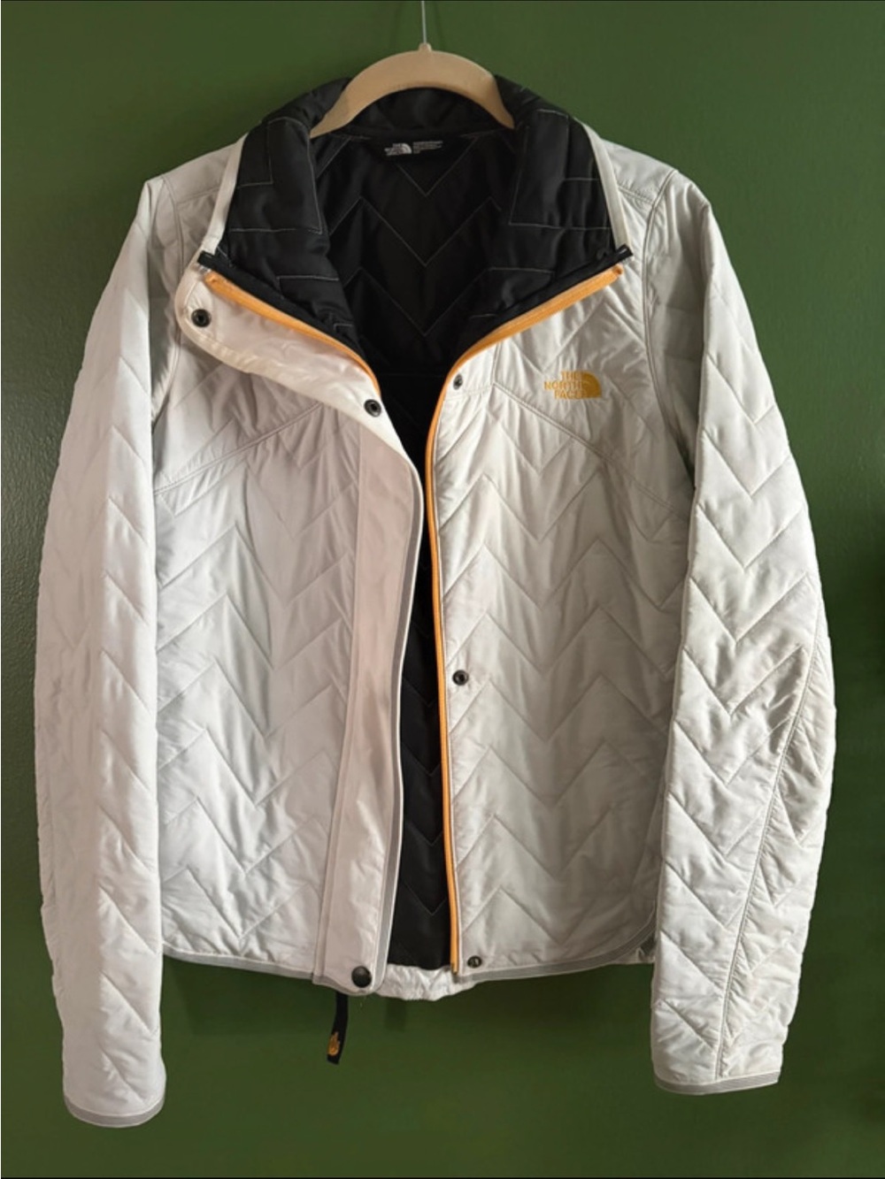 The North Face White Quilted Puffer Jacket with Black Lining and Yellow Trim